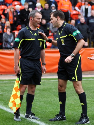 Referee Dougie McDonald talking to assistant Steven Caven during a Clydesdale Bank Scottish Premier League match.