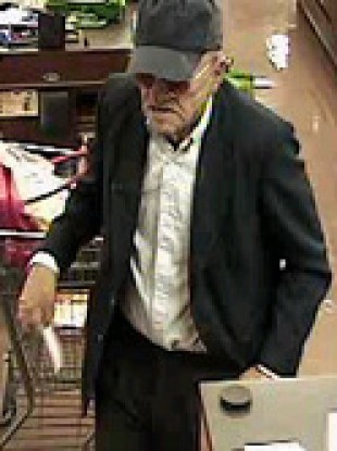 A CCTV still showing the wanted man during a robbery in June 2010.