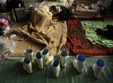 A youngster rests in a school gymnasium being used as a center for people to stay at whose homes were damaged by the tsunami in Ofunato, Japan, Wednesday, March 16, 2011.