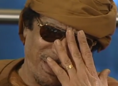 Muammar Gaddafi laughs at an interviewer's suggestion that he leave Libya, from a clip aired by the BBC.