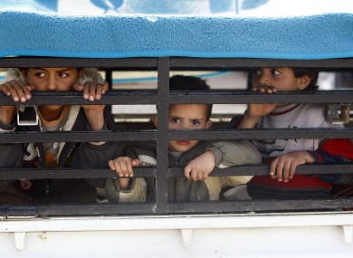 Libyan children cross the Libya-Tunisian border in an effort to escape fierce fighting
