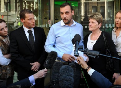 Paul King (centre), the son of Ian Tomlinson, and his widow Julia (2nd right) speak to the press after the inquest into Mr Tomlinson's death was delivered as an unlawful killing.