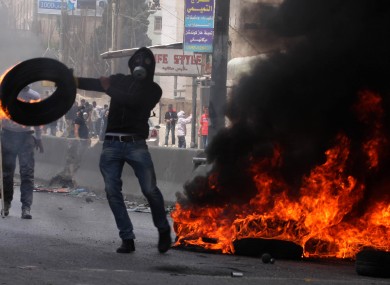 Palestinians clash with Israeli soldiers at an Israeli checkpoint between Jerusalem and Ramallah