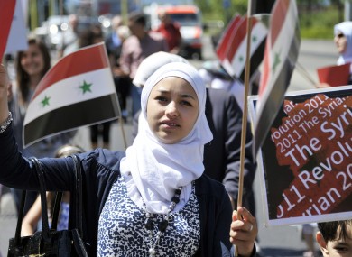 A young woman joins a solidarity protest for Syria in Switzerland.