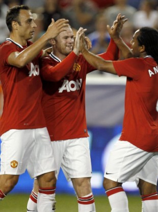 Rooney celebrates with Anderson and Berbatov after the opening goal.