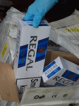 A Customs official holds some of the cigarettes seized at Dublin Port today.