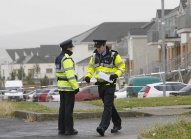 Gardaí near the scene of the crime in Tallaght yesterday.