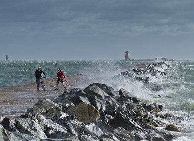 Cyclists brave the storm at the Great South Wall near Poolbeg yesterday.