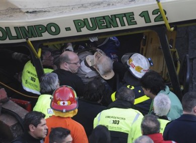 One of the injured passengers is carried out of the train involved in today's crash in Buenos Aires.