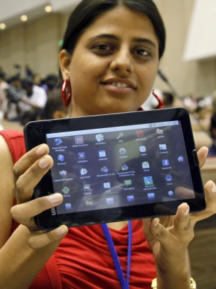 An Indian student poses with the supercheap Aakash tablet computer which she received during its launch in New Delhi, India on Wednesday.