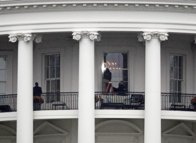 Law enforcement officers photograph a window at the White House in Washington. A bullet hit an exterior window of the White House and was stopped by ballistic glass, the Secret Service said.