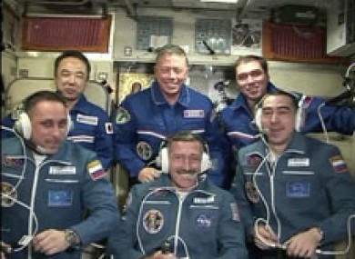 The new arrivals sit in front after being welcomed aboard the ISS.