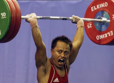 Indonesia's Jadi Setiadi competes in the clean and jerk of the Men's 56 kg category at the 26th Southeast Asian (SEA) Games in Palembang, South Sumatra, Indonesia, Friday, Nov 18, 2011.