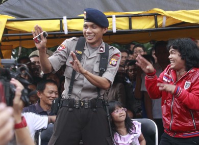 police officer Norman Kamaru, center, dances with a fan during a show in Jakarta at the height of his fame earlier this year