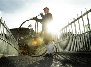 Pete Matthews with his penny farthing on Dublin's Ha'penny Bridge for the launch of the Temple Bar Tradfest today