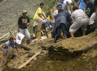 Residents dig through the rubble following a landslide that occurred at the small-scale mining community of Pantukan, Compostela Valley in southern Philippines.