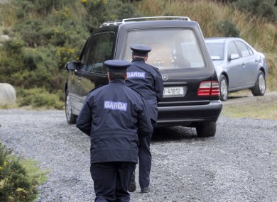 Gardaí follow the hearse at the scene of the body's discovery on Monday.