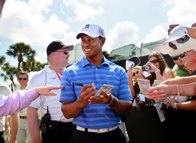 Tiger Woods signs autographs during a practice round for the Honda Classic.