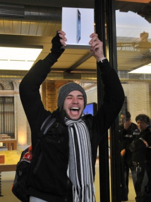 Craig Jobbins, from Romford, celebrates getting one of the first new Apple iPads at the company's Covent Garden store on the release of the latest version of the tablet computer on Friday.