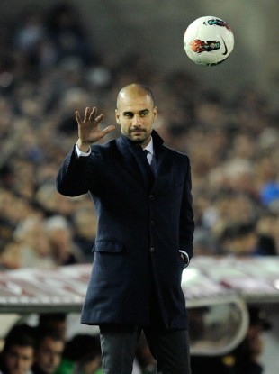 Barcelona head coach Pep Guardiola throws back the ball last night.