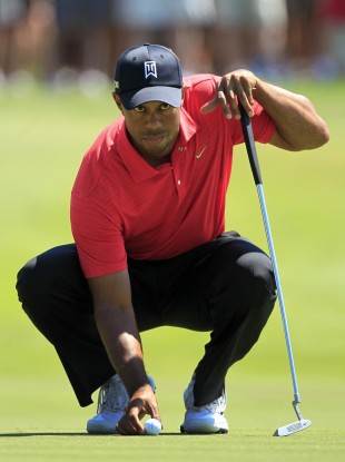 Tiger Woods lines up a putt on the second green.
