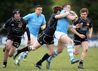 Ronan O'Mahony of Garryowen is tackled by Ballymena's Mark Irwin.