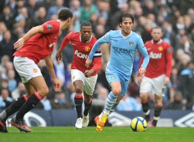 David Silva closely guarded by Rio Ferdinand and Patrice Evra.