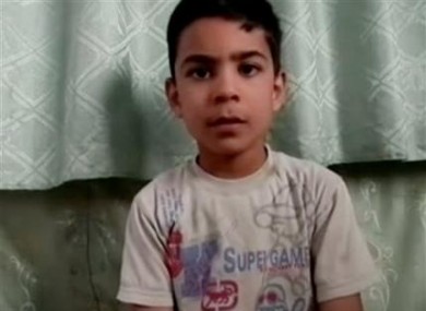 This image made from amateur video, released by the Houla Media Office and accessed Thursday, May 31, 2012 purports to show 11-year-old Ali el-Sayed, a survivor of the Houla massacre that began Friday and left 108 people dead, many of them children and women.