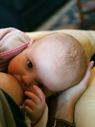 A woman breastfeeding her five-month-old child