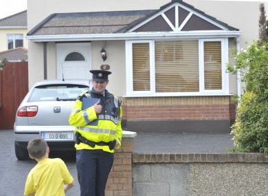 A Garda outside the house where the body of the woman was discovered this morning.
