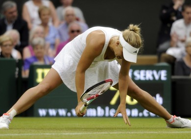 Caroline Wozniacki is beaten on Centre Court yesterday.