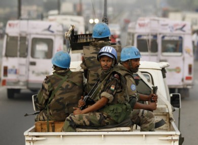 In this Jan. 10, 2011 file photo, United Nations soldiers from Niger conduct a patrol through the streets of Abidjan, Ivory Coast.