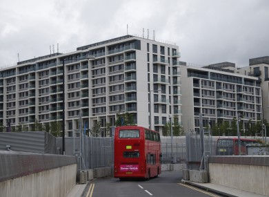A double decker bus drives past the Olympic Village. (File photo)