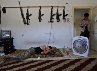 A Syrian rebel sleeps at a rebel HQ in the outskirts of Aleppo.