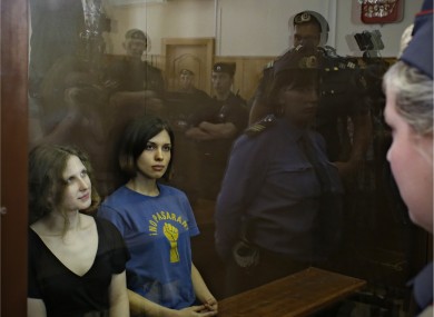 Two members of Pussy Riot, Maria Alekhina and Nadezhda Tolokonnikova, in the glass cage in the Moscow courtroom on Friday
