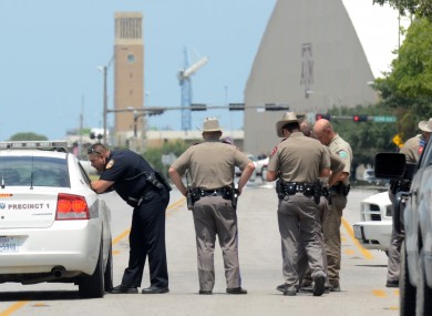 Texas State troopers and Brazos Valley lawmen work the scene of the shooting of two fellow law officers,