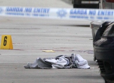 Discarded clothing and bloodstains visible at the scene of the shooting today