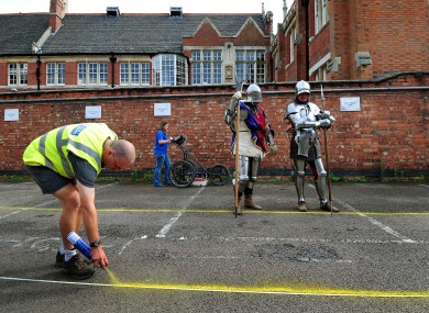 Richard III watches while archaeologists prepare to dig for him. Kidding. It's just actors dressed up.