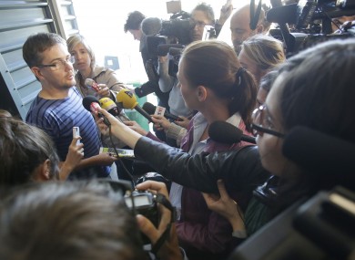 Publishing director of the satyric weekly Charlie Hebdo, Charb, holds the newspaper as he talks to the media in Paris today.