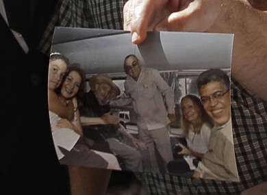 Former Venezuelan Vice President Elias Jaua shows a picture of Cuba's leader Fidel Castro, third from left, at the Hotel Nacional in Havana Sunday October 21, 2012