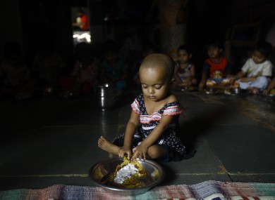 Malnourished Indian children (no names available) eat a meal at the Apanalaya center, an organization working for the betterment of slum children, in Mumbai, India, Tuesday, Oct. 9, 2012.