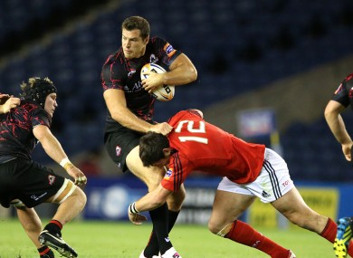 Edinburgh's Tim Visser tackled by James Downey of Munster.