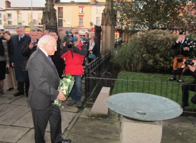 The President lays a wreath at the Great Hunger Memorial in Liverpool yesterday.