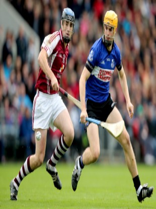 Sarsfields Eanna Martin (right) in action in the Cork county final.
