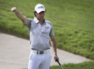 Rory McIlroy of Northern Ireland reacts after sinking a putt on the 18th green to finish third at the Singapore Open golf tournament.