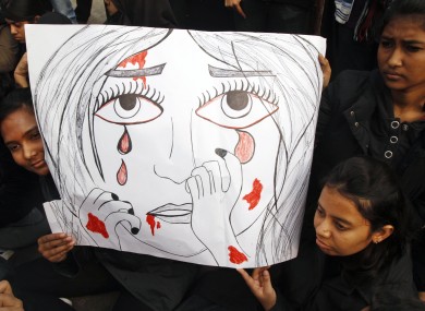 Indian students hold a placard as they participate in a protest rally in Allahabad, India yesterday