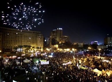 Fireworks burst over Tahrir Square as protesters gather in Cairo this evening