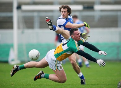 Laois player Padraig McMahon and Offaly's Ross Brady.