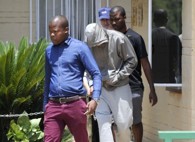 Paralympic Athlete Oscar Pistorius leaves the Boshkop Police Station ahead of a visit to hospital for medical examinations.