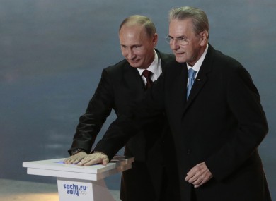 Russian President Vladimir Putin, left, and IOC President Jaques Rogge press a symbolic button to mark one year to the start of the 2014 Winter Olympics, in Sochi, Russia.